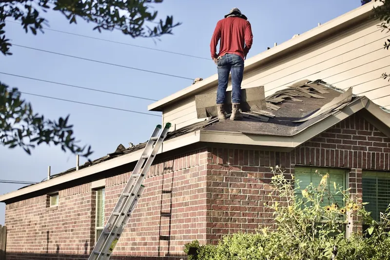 Professional roofer working on a residential roof in Hopelawn